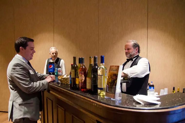 Anthony Bianco, program coordinator for the Camden County Improvement Authority, gets a glass of locally produced wine at the "Visit South Jersey" wine and cheese fundraiser on Feb. 24. (RACHEL WISNIEWSKI / Staff Photographer)