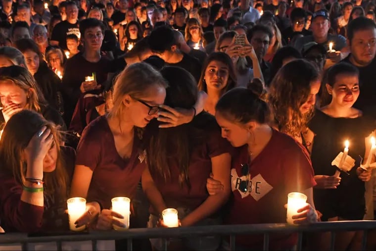 Mourners gather at a vigil that was held for the victims of the mass shooting at Marjory Stoneman Douglas High School in Parkland, Fla., on Thursday, Feb. 15, 2018.