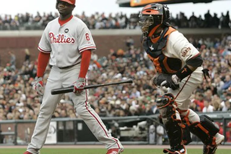 Ryan Howard, left, reacts after being called out on strikes against Giants pitcher Tim Lincecum in the first inning of last night's game in San Francisco. The Phillies lost, 2-0. At right is the Giants' Bengie Molina. (AP Photo/Jeff Chiu)