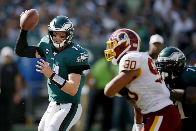 Eagles quarterback Carson Wentz (11) looks to pass during a game against the Washington Redskins at Lincoln Financial Field in South Philadelphia on Sunday, Sept. 8, 2019.