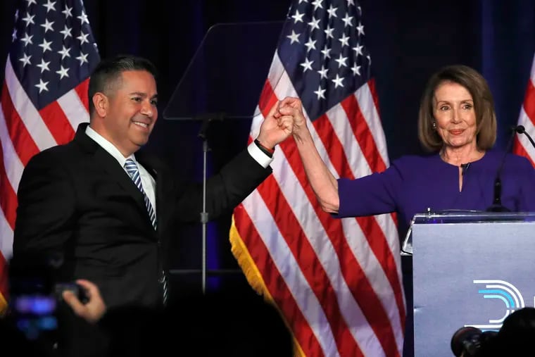 DCCC Chair Ben Ray Lujan, left, and House Democratic Leader Nancy Pelosi of Calif., gesture after speaking to a crowd of volunteers and supporters of the Democratic party at an election night event at the Hyatt Regency Hotel in Washington.
