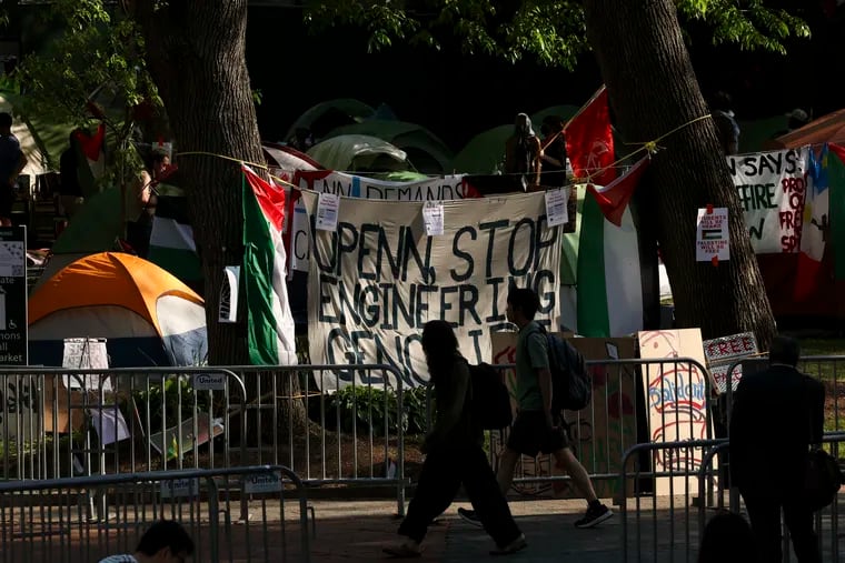 People walk past the Gaza Solidarity Encampment at Penn on Tuesday.