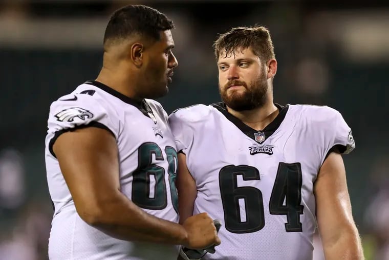 Eagles offensive tackle Jordan Mailata (68) talks with offensive lineman Brett Toth after a preseason game against the New England Patriots in August.