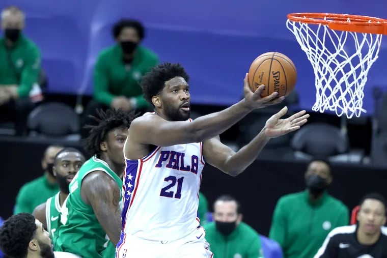 Joel Embiid goes up for a basket against the Celtics during the first half.