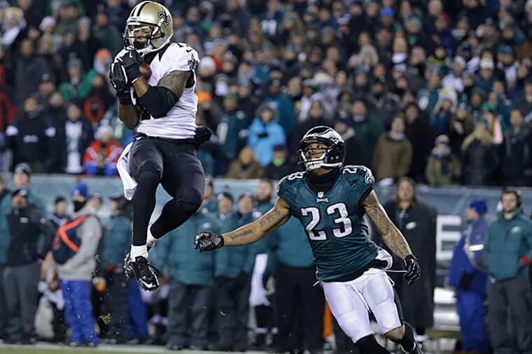 The Saints' Robert Meachem, left, pulls in a pass as Philadelphia Eagles' Patrick Chung looks on during the second half of an NFL wild-card playoff football game, Saturday, Jan. 4, 2014, in Philadelphia. (Matt Rourke/AP)