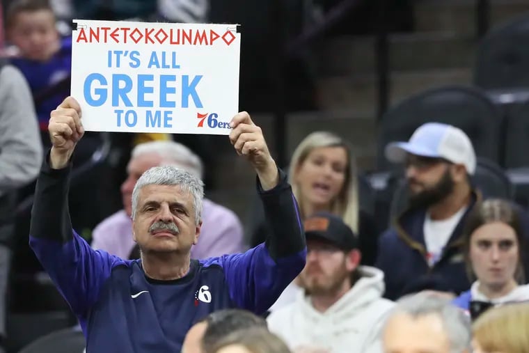 A Sixers fan holds up a sign in reference to Milwaukee Bucks forward Giannis Antetokounmpo before the start of the game at the Wells Fargo Center.