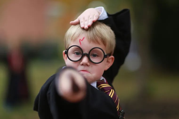 Jamison Walsh, 5, of Port Carbon, Pa., casts a spell in Chestnut Hill at a Harry Potter festival. ( DAVID SWANSON / Staff Photographer )