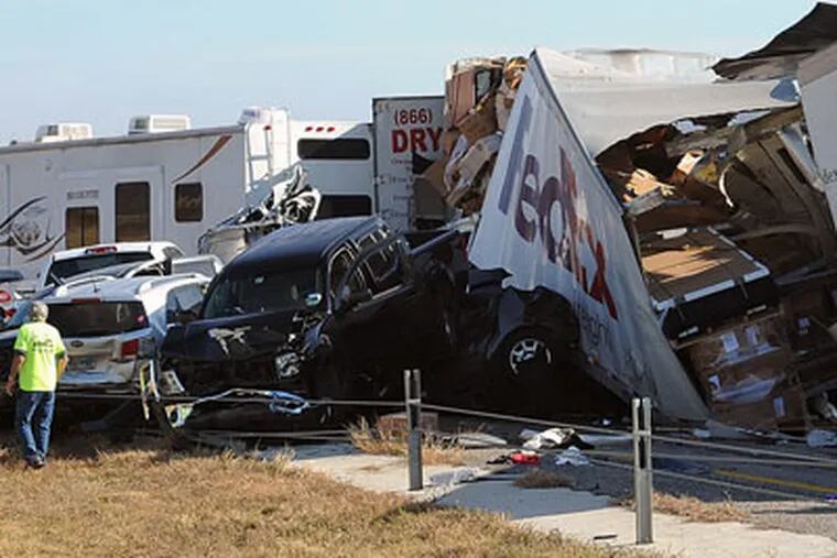 Cars and Trucks are piled on Interstate 10 in Southeast Texas Thursday Nov. 22, 2012.  The Texas Department of Public Safety says at least 35 people have been injured in a more than 50-vehicle pileup.    (AP Photo/The Beaumont Enterprise, Guiseppe Barranco) Mandatory Credit