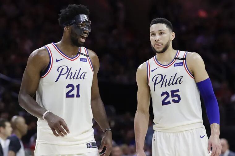 Center Joel Embiid  (left) and point guard Ben Simmons led the Sixers to a turnaround season.