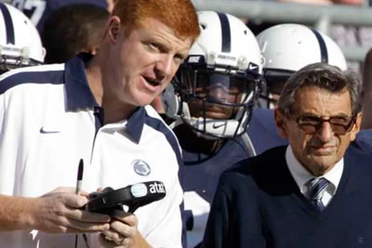 Assistant football coach Mike McQueary, left, talks with head coach Joe Paterno during 2008 game.  (AP Photo/Gene Puskar, File)