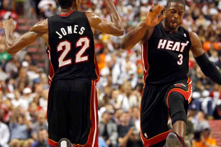 Heat's Dwyane Wade (right) celebrates after James Jones made a three-pointer in second quarter.