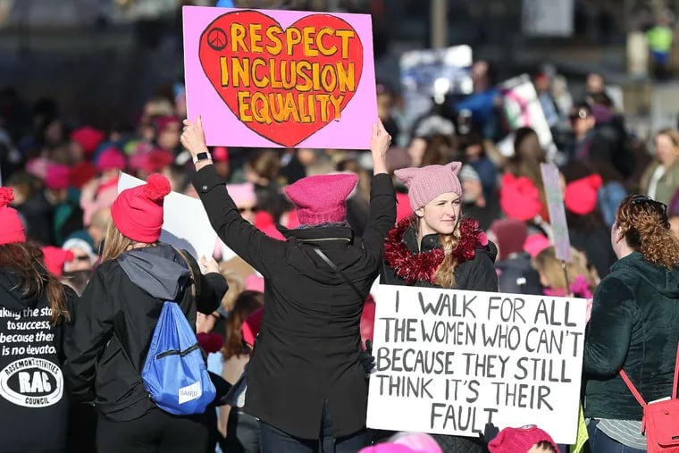 Kristyn Stickley, 22, of West Chester, PA, at right, holds a sign during the Women&#039;s March on the Ben Franklin Parkway in Philadelphia, PA on Jan. 20, 2018.