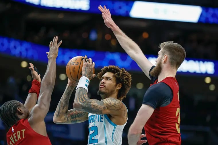 Charlotte Hornets swingman Kelly Oubre Jr. shoots between Cleveland's Caris LeVert and Dean Wade on March 14.