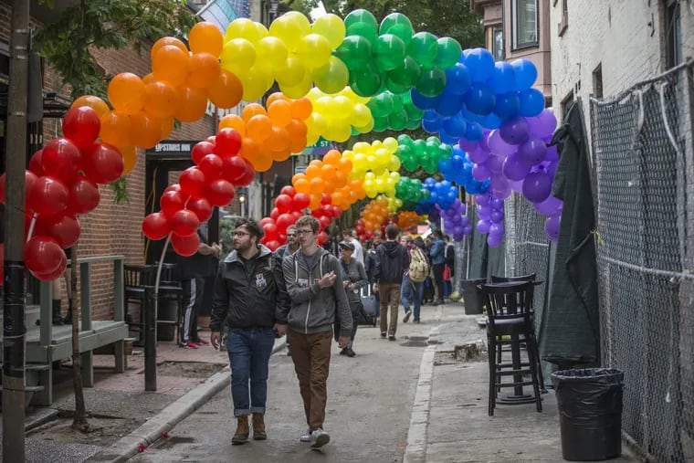 Rainbow balloon arches decorate Camac Street. (MICHAEL BRYANT / Staff Photographer)