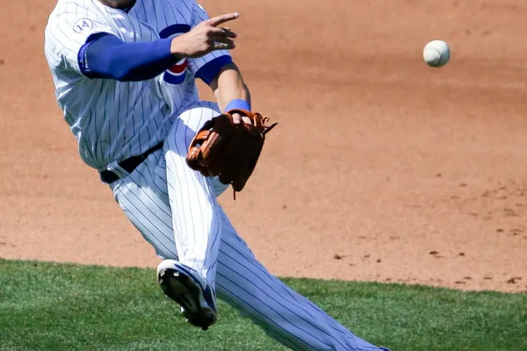 ASSOCIATED PRESS Cubs third baseman Mike Olt throws out Royals' Eric Hosmer at first in game in Mesa, Ariz.