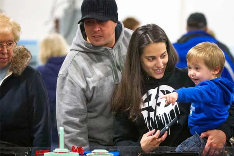 Blake Foster with parents Mark and Megan at the World's Greatest Hobby on Tour show. (Ed Hille / Staff Photographer)
