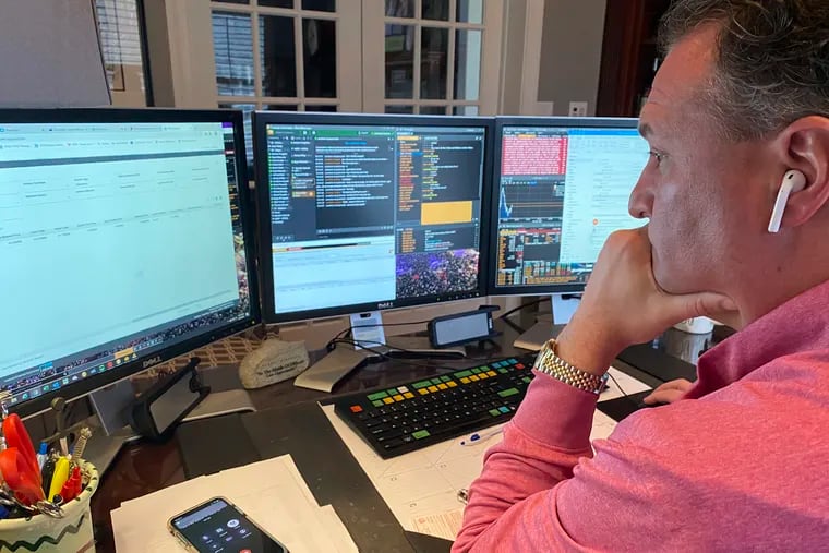 Jonathan Corpina, senior managing partner at Meridian Equity Partners Inc., who normally works on the New York Stock Exchange trading floor, works in his home office in Armonk, NY., Wednesday.