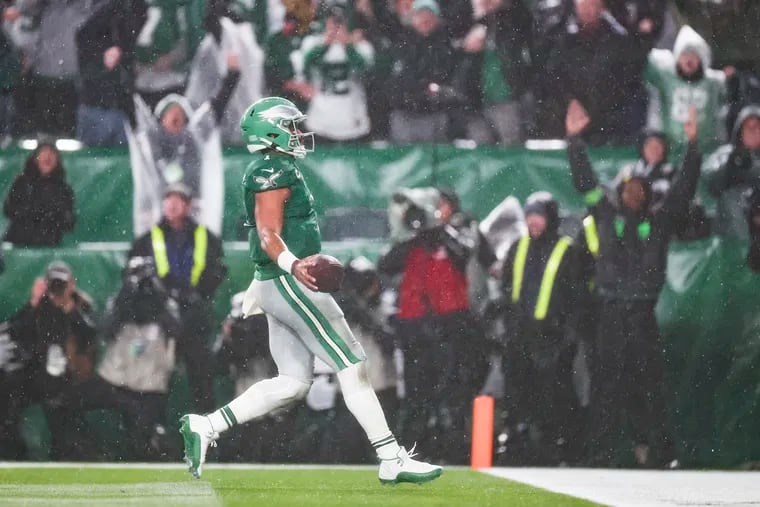 Eagles quarterback Jalen Hurts runs through the end zone in the game-winning touchdown in overtime to beat the Bills on Sunday.