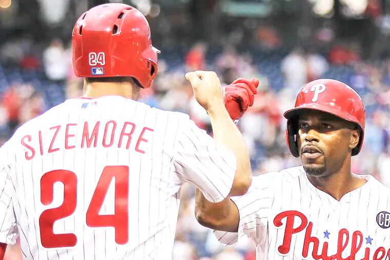 Phillies' Grady Sizemore greets Jimmy Rollins at home plate after his two-run homer against the Nationals in the third inning.