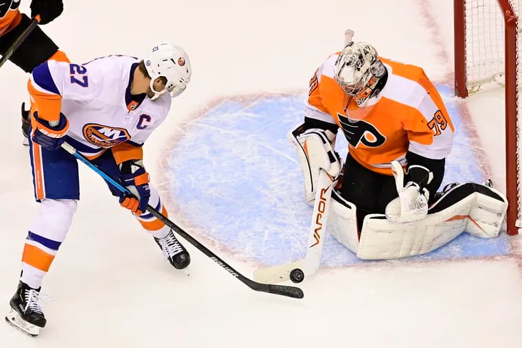 Flyers goaltender Carter Hart makes a save against Islanders left winger Anders Lee during a Stanley Cup playoff game in September.  The NHL is hoping to return in mid-January.