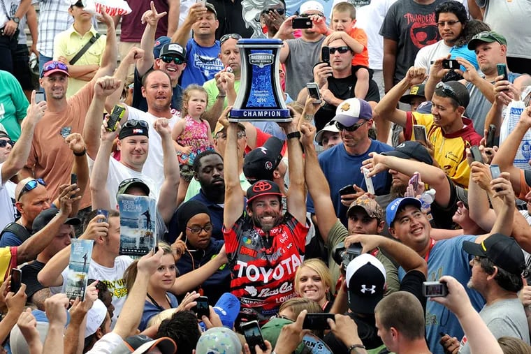 Mike Iaconelli of Pittsgrove, N.J., hoists the trophy he received for winning the Bassmaster Elite Series fishing competition on the Delaware River. TOM GRALISH / Staff Photographer