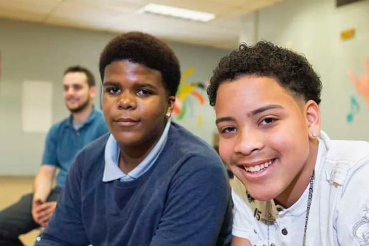 Two 8th graders at East Camden Middle School. Vaughn Williams (center), and Fredrick Henderson, (rignt) both 14, completed a project and with their teacher Chase Miller (left) flew to Colorado where they created a TED Talk on their subject. (ED HILLE / Staff Photographer )
