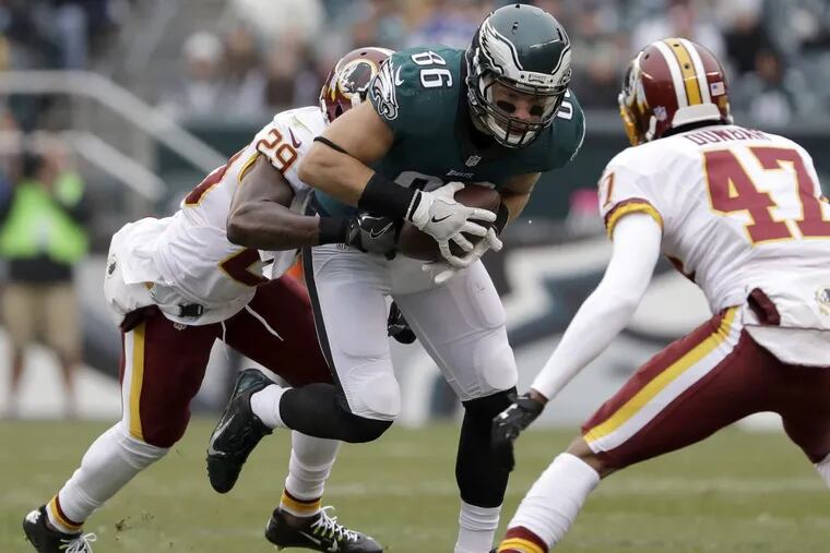 Eagles' tight end Zach Ertz runs with the football against Washington Redskins' strong safety Duke Ihenacho (left) and cornerback Quinton Dunbar during the first-quarter on Sunday, December 11, 2016 in Philadelphia. YONG KIM / Staff Photographer