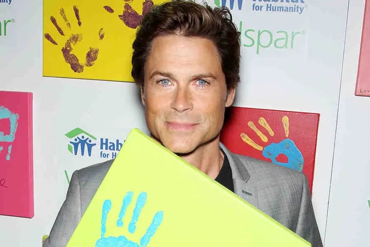 Rob Lowe unveils his handprints at an auction held in New York on Monday to benefit Habitat for Humanity.