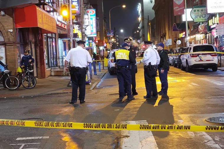 Police at the scene of a shooting at 10th and Race Streets in the heart of Chinatown Thursday night.