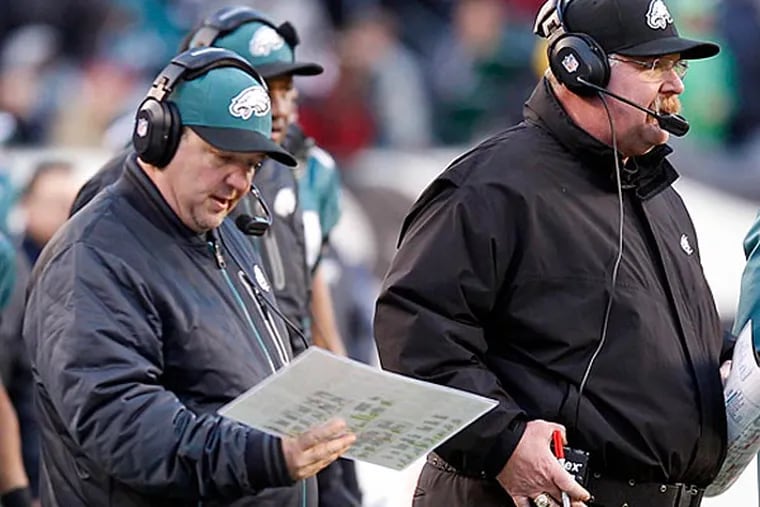 Eagles head coach Andy Reid stands next to offensive coordinator Marty Mornhinweg and Michael Vick late in the fourth quarter against the Washington Redskins on Sunday, December 23, 2012. (Yong Kim/Staff Photographer)