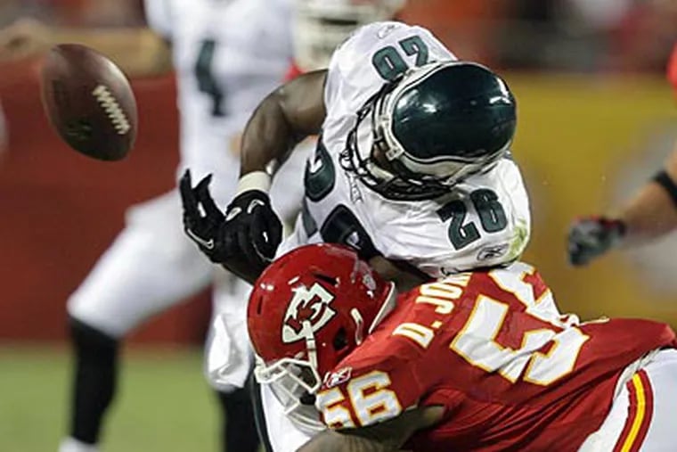 Mike Bell fumbles during the second quarter against the Chiefs. (Yong Kim/Staff Photographer)