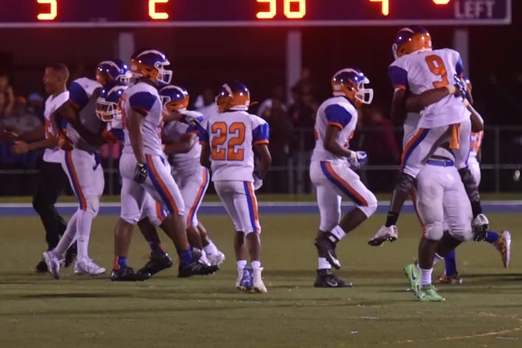 JAUG23P Millville football players celebrate their last-minute win ,at St. Augustine. They scored a TD with 25 seconds to go, ,and then, the defense held. Photo / Curt Hudson,,,,,,,,,,,,,,,,,,,,,,,,,,,,,,,,,,,,,,,,,,,,,