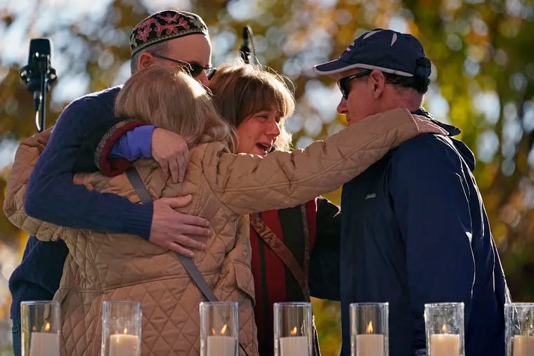 Mourners hug last month after lighting a candle in memory of Melvin Wax, one of 11 Jewish worshippers killed four years ago when a gunman opened fire at the Tree of Life synagogue in Pittsburgh.