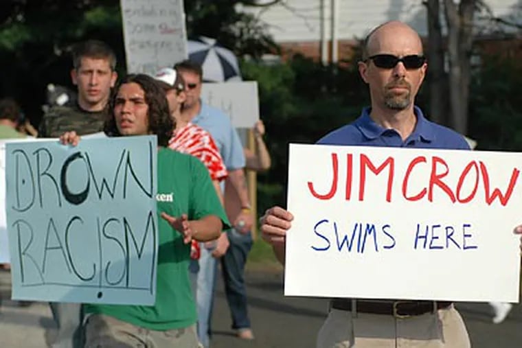 Kevin Peter (right) was among protesters standing outside the Valley Swim Club yesterday in Huntingdon Valley. (James Heaney / Staff Photographer)