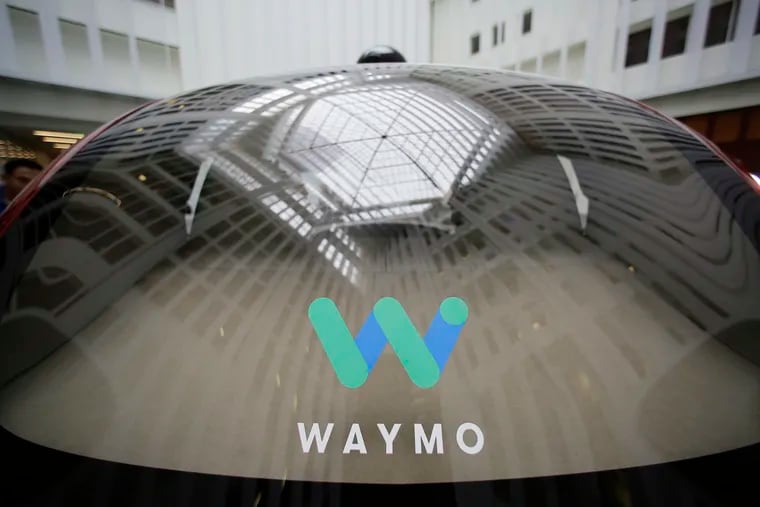 FILE - In this Dec. 13, 2016, file photo, a skylight is reflected in the rear window of a Waymo driverless car during a Google event in San Francisco.