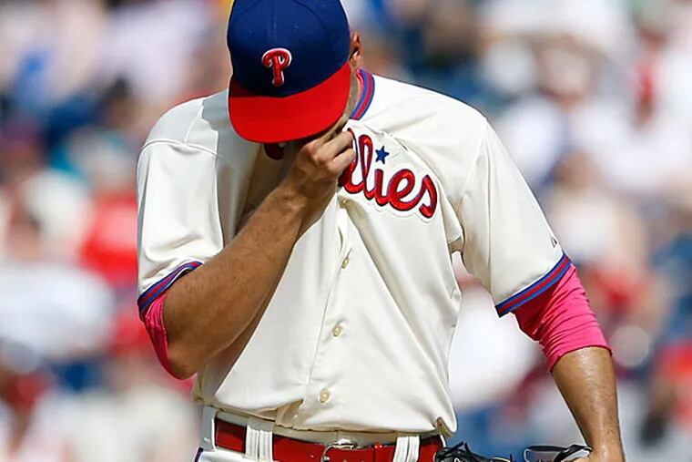 Jeanmar Gomez wipes his face after giving up two runs. (Yong Kim/Staff Photographer)
