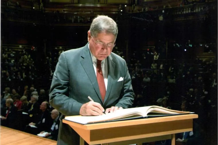 Photo of Alberto Ibarguen during induction into the American Academy of Arts &amp; Sciences.  The photo shows Alberto Ibarguen signing the membership ledger that was first signed by John Adams.