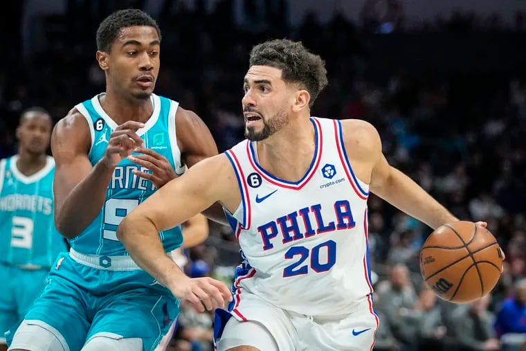 Philadelphia 76ers forward Georges Niang (20) moves around Charlotte Hornets guard Theo Maledon (9) during the second half of an NBA basketball game Wednesday, Nov. 23, 2022, in Charlotte, N.C. (AP Photo/Rusty Jones)