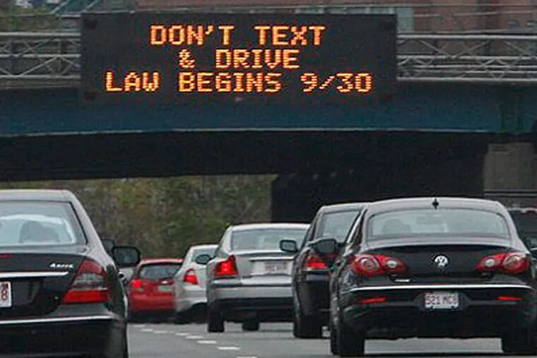 In this photo taken Sept. 24, a sign over the Massachusetts Turnpike in Boston alerts motorists to a new state law banning texting while driving. Pennsylvania may soon follow suit. (AP Photo / Bill Sikes)