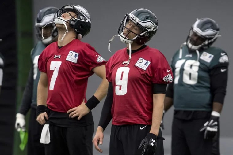 Eagles starting quarterback Nick Foles (#9), his backup Nate Sudfeld (7) and their teammates stretch during practice on Dec. 14.
