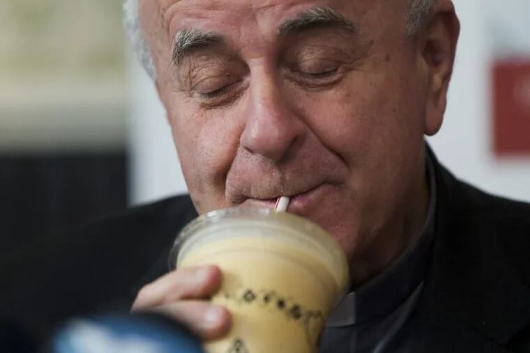Archbishop Vincenzo Paglia samples a milkshake during a news conference to pick a milkshake for the upcoming World Meeting of Families, Monday, March 9, 2015, at a Potbelly Sandwich Shop in Philadelphia. (AP Photo/Matt Rourke)