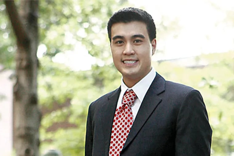 Pat Pow-anpongkul , who graduates from Wharton in May, received a job offer from Lehman Bros. after working there as a summer intern. But like other seniors at the business school, he is now reassessing his career path. (Michael Perez / Inquirer)