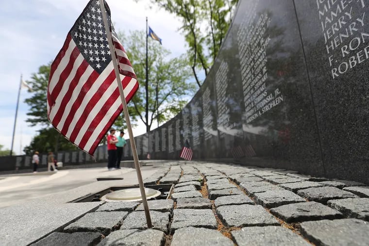 An American flag rests near the wall at the Vietnam Veterans Memorial in Philadelphia on Sunday.