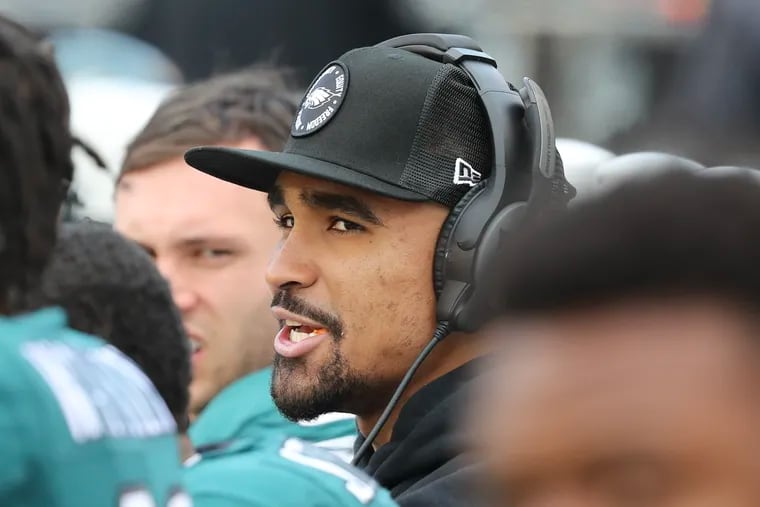 Injured Eagles quarterback Jalen Hurts watches his teammates take on the New Orleans Saints from the bench during the second quarter Sunday.