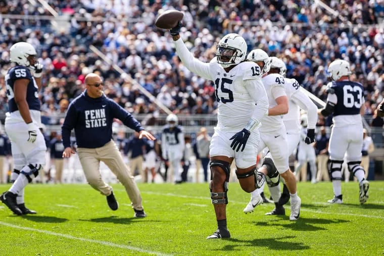 Amin Vanover (15) celebrates on the field with head coach James Franklin, left, after intercepting a pass during the Penn State Spring football game at Beaver Stadium on Saturday in State College.