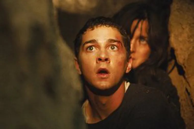 Shia LaBeouf as Kale, with Carrie-Ann Moss as his mother, is under house arrest and seeing creepy doings through his binoculars.