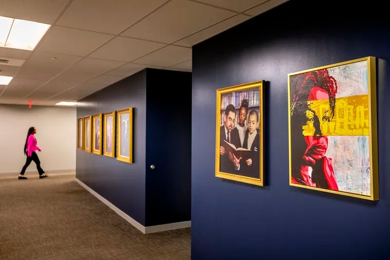 The newly installed portrait (right) of Joyce Wilkerson, a current school board member and former board president of the Philadelphia School Board and former chair of the School Reform Commission (SRC) photographed at Philadelphia School District headquarters. The artist is Sydney Carter. On wall at left, in the hallway leading to the second floor auditorium is former board president and SRC Chair Pedro Ramos, along with other former presidents.