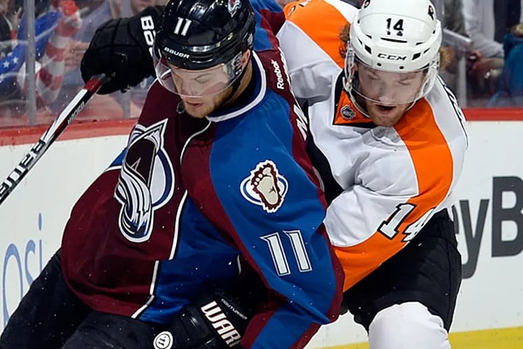 Colorado Avalanche left wing Jamie McGinn (11) skates against Philadelphia Flyers center Sean Couturier (14) during the first period of an NHL hockey game on Thursday, Jan. 2, 2014, in Denver. (AP Photo/Jack Dempsey)
