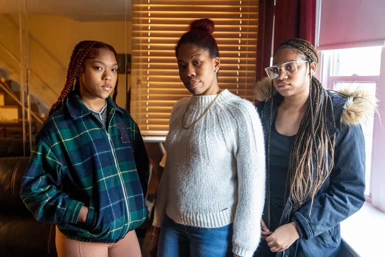 Aniyah Tull, 17, right, with her mother, Christina, center, and sister Kristina, in their home in Philadelphia on Feb. 3. A Common Pleas Court judge recently ruled against a motion to allow Aniyah Tull to return in person to the Mathematics, Civics and Sciences Charter School.