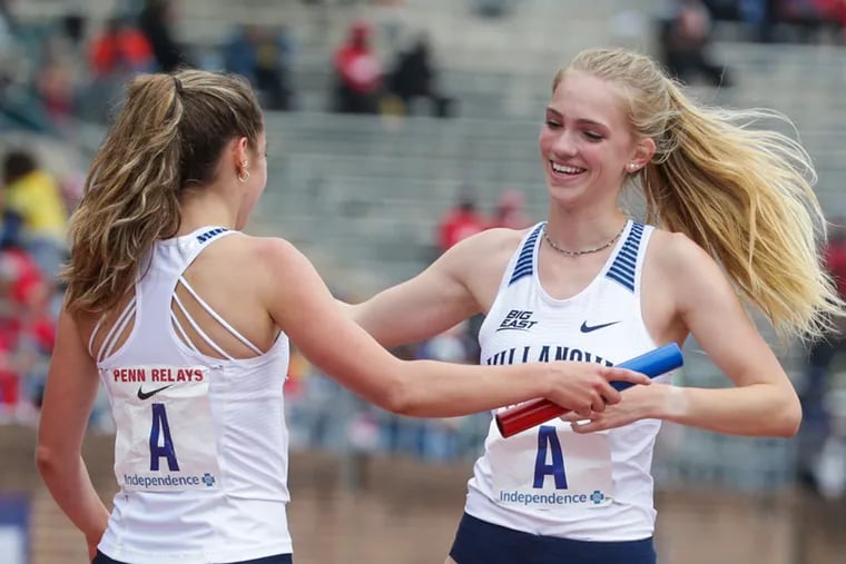 Villanova's Rachel McArthur, right, runs up to hug Nicole Hutchinson after they won the College Women's 4x1500 Championship of America Invitational at the 2019 Penn Relays at Franklin Field on Friday, April 26, 2019.